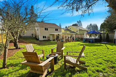a view of an house with backyard and patio