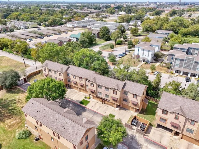 an aerial view of a house with a yard