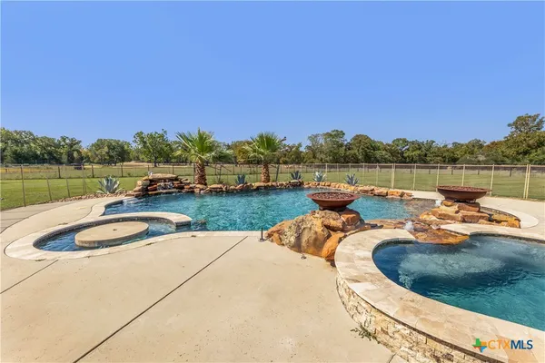 a view of a lake with a yard and a deck