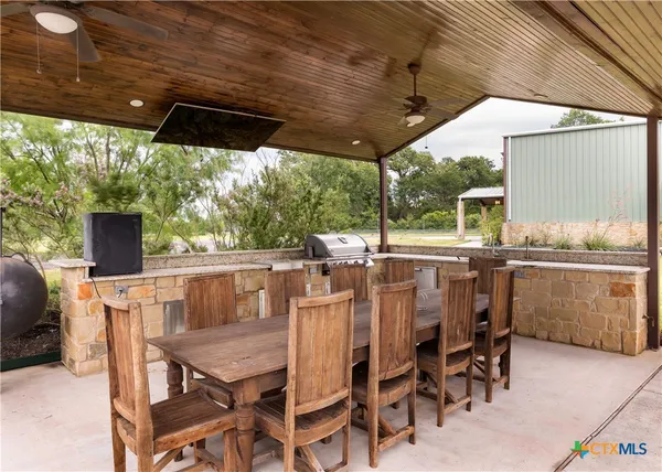 a view of an outdoor dining space with a table and chairs