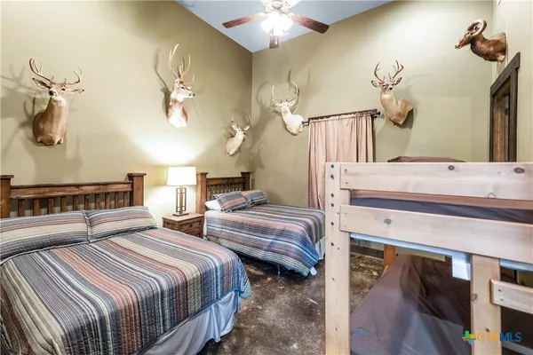 a bedroom with bed and a chandelier