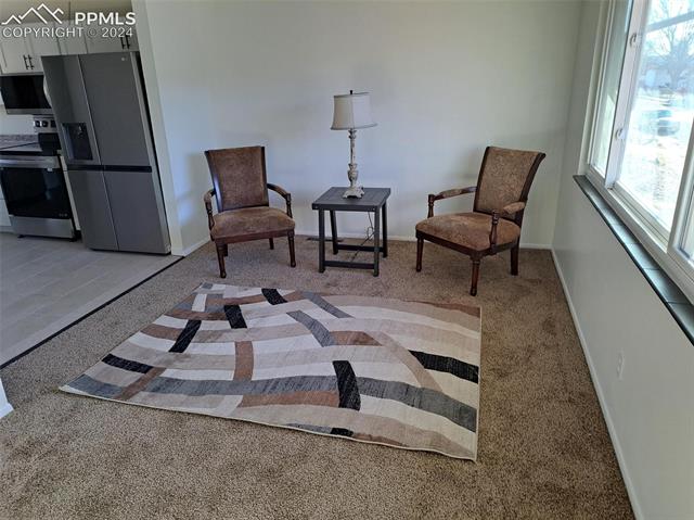 1818 Whitman Road Colorado Springs, CO 80910 - Photo 4 of 4 Sitting room with a wealth of natural light and light tile flooring