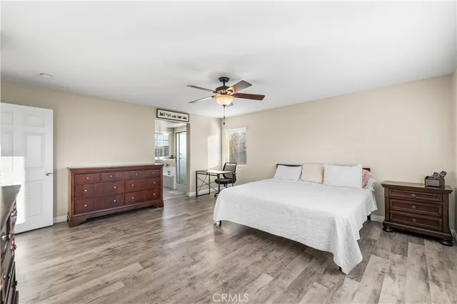 a spacious bedroom with a bed and a chandelier