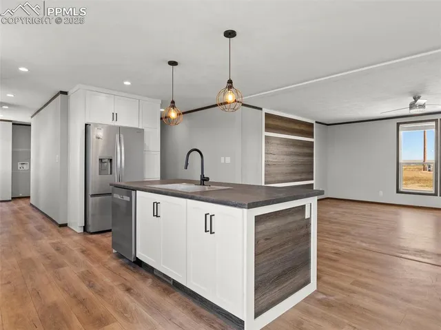 a kitchen with white cabinets and white appliances