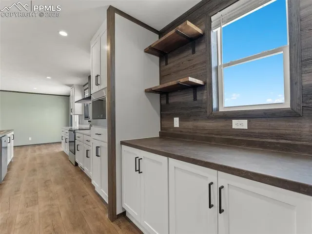 an empty room with a ceiling fan and a window