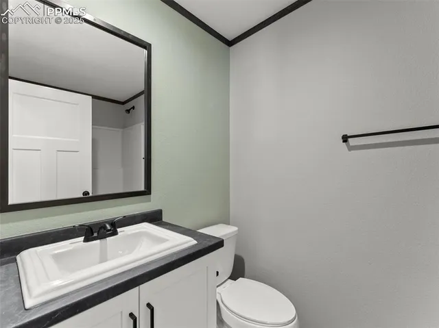 a bedroom with a large bed and a potted plant