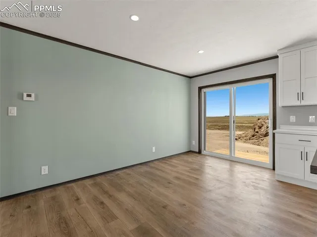 a kitchen with stainless steel appliances granite countertop a stove a sink and a granite counter tops with white cabinets