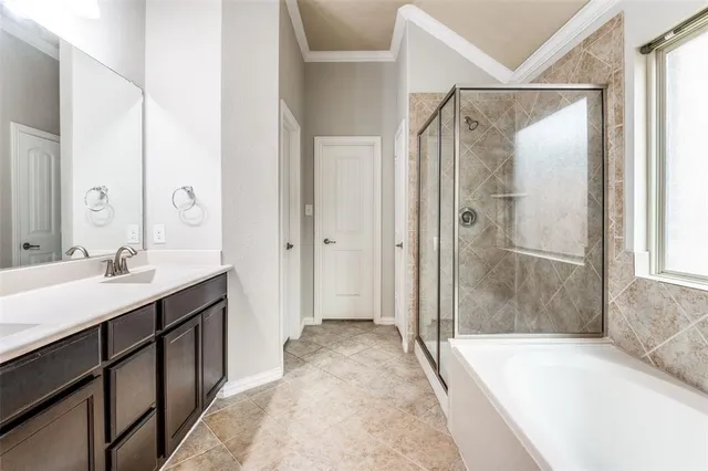 a spacious bathroom with a bathtub shower sink and mirror