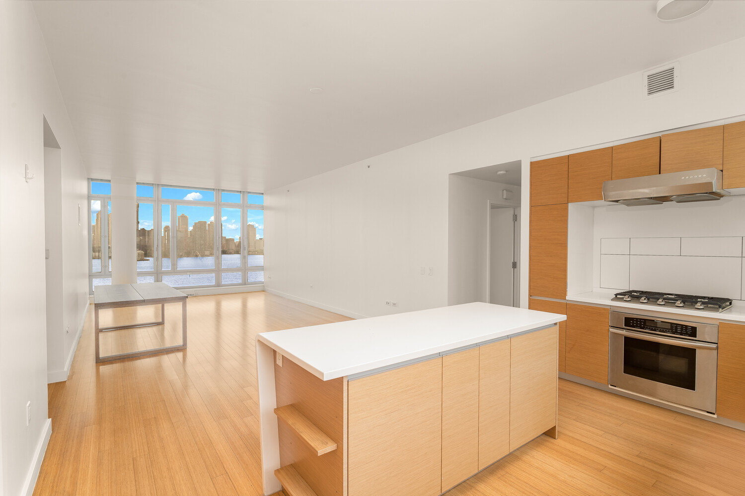 2 River Terrace, Unit 15T Manhattan, NY 10282 - Photo 4 of 22 a kitchen with stainless steel appliances a stove a sink and a refrigerator