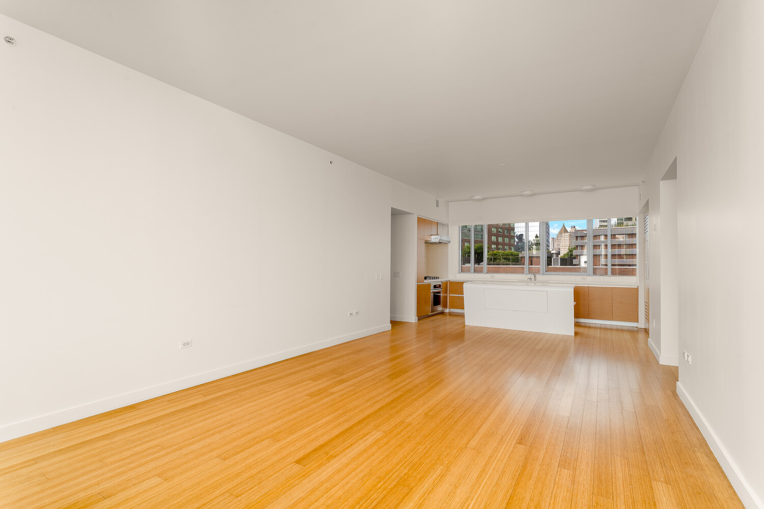 2 River Terrace, Unit 15T Manhattan, NY 10282 - Photo 6 of 22 a view of an empty room with wooden floor