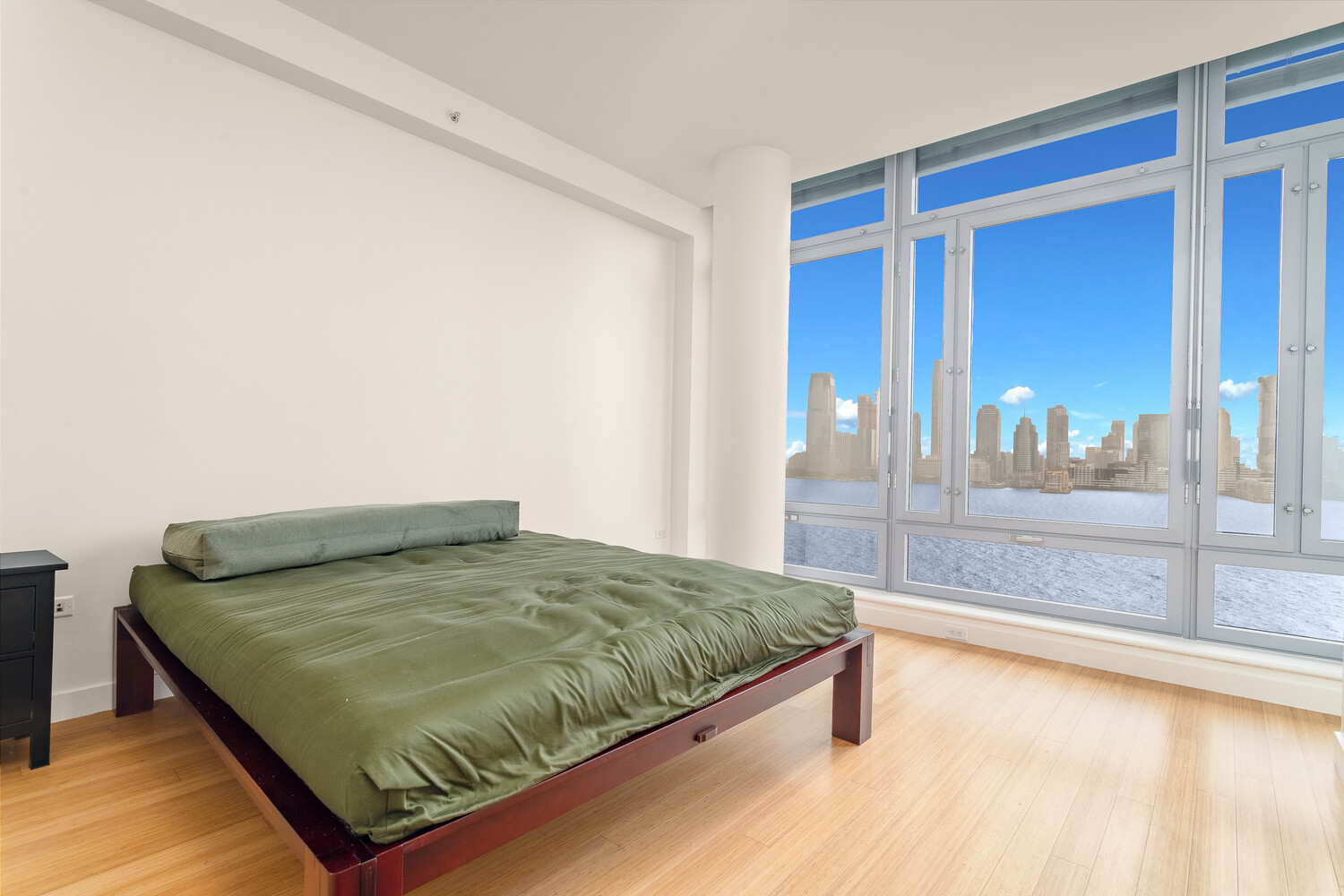 2 River Terrace, Unit 15T Manhattan, NY 10282 - Photo 9 of 22 a bedroom with a bed and glass door