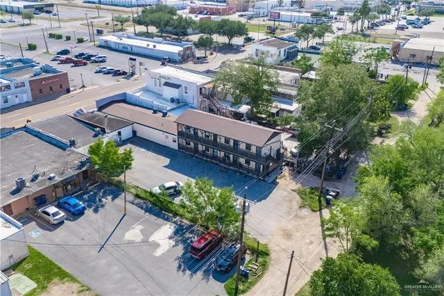 an aerial view of a house with garden space and street view