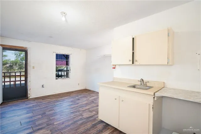 a view of a room with wooden floor and window