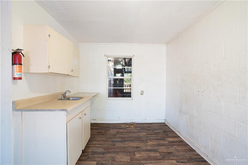 130 North Texas Avenue, Unit 4 Mercedes, TX 78570 - Photo 6 of 18 a view of a kitchen with a sink and dishwasher
