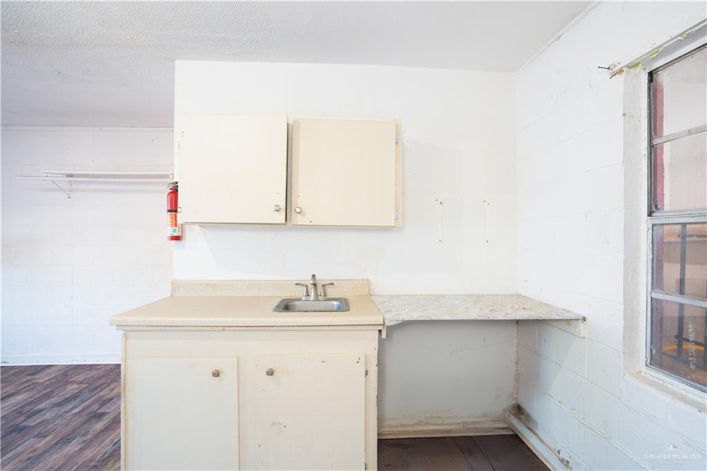130 North Texas Avenue, Unit 4 Mercedes, TX 78570 - Photo 7 of 18 a bathroom with a sink and a mirror