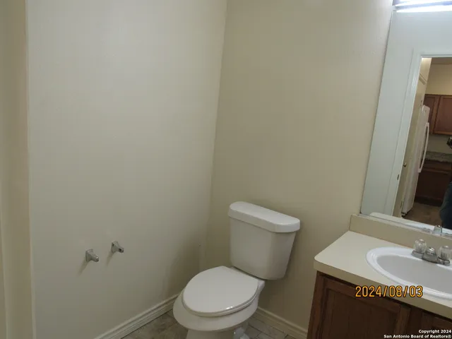 a white toilet sitting next to a bathroom sink
