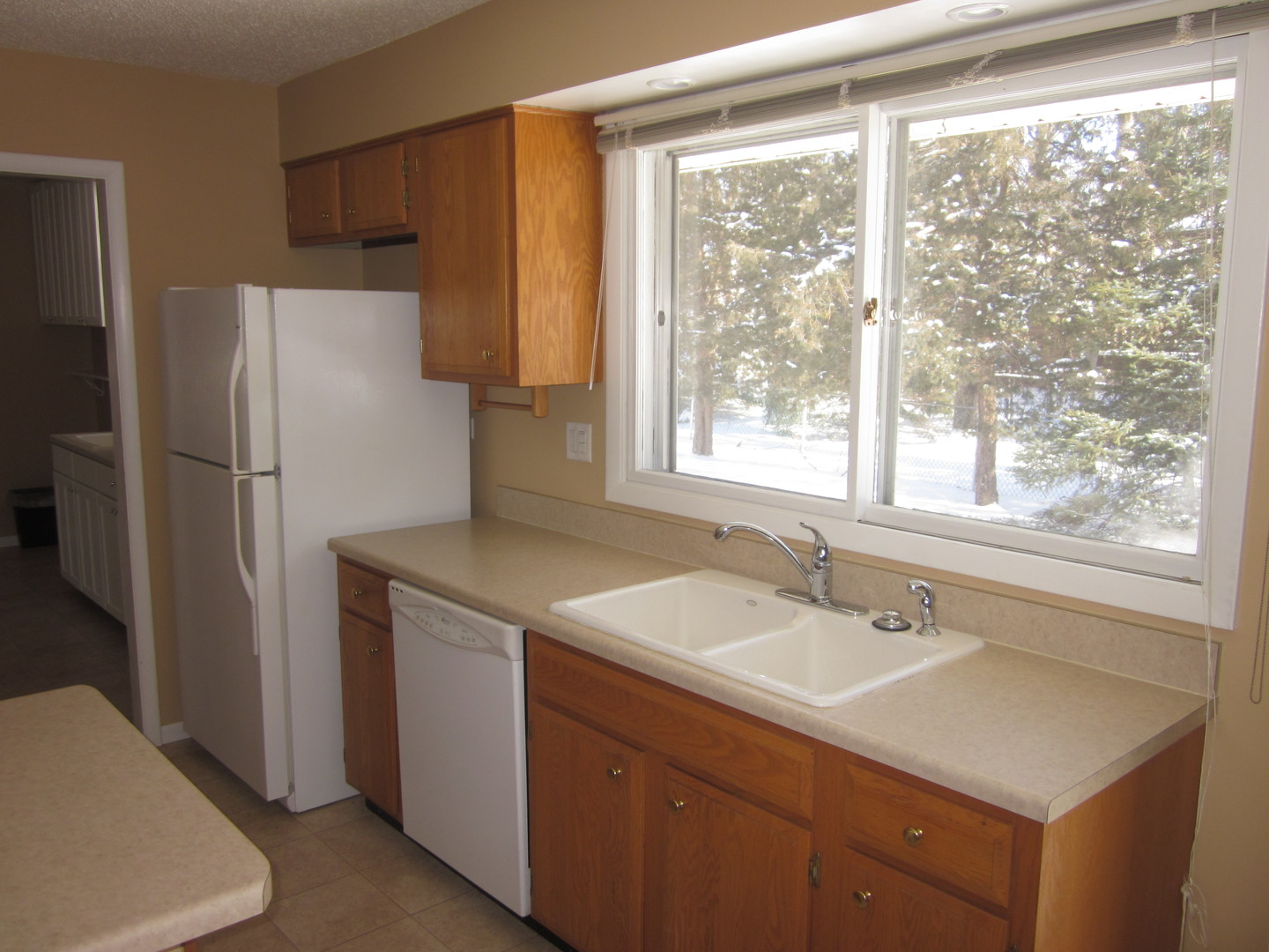 511 Northgate Road Lindenhurst, IL 60046 - Photo 8 of 19 a kitchen with a sink cabinets and a refrigerator