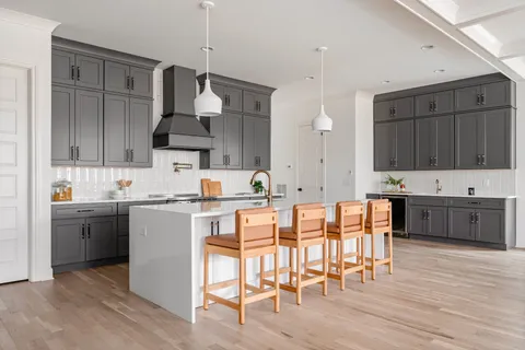 a kitchen with granite countertop a stove a sink and a microwave