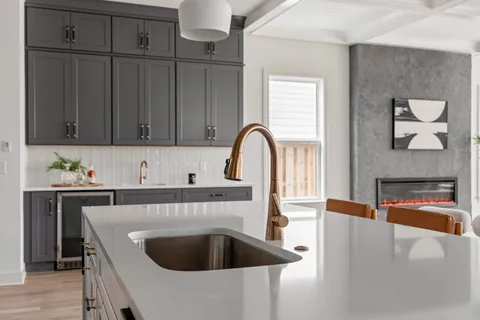 a kitchen with stainless steel appliances a refrigerator sink and cabinets