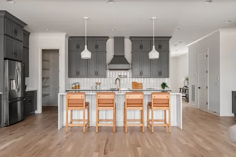 a living room with fireplace furniture and a large window