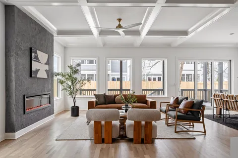 a living room with furniture kitchen view and a fireplace
