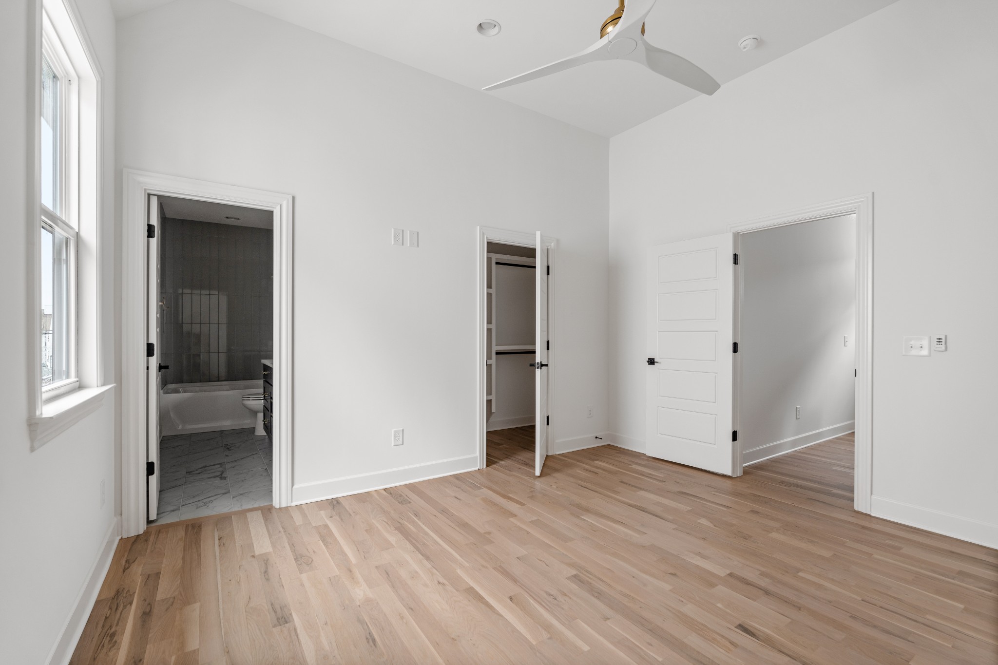 1037 Mitchell Road, Unit B Nashville, TN 37206 - Photo 27 of 51 an empty room with wooden floor & windows and a bathroom