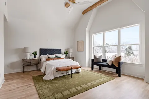 a bedroom with bed and window