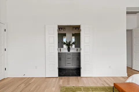 a bathroom with a double vanity sink mirror and shower