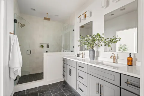a bathroom with a sink a mirror and shower