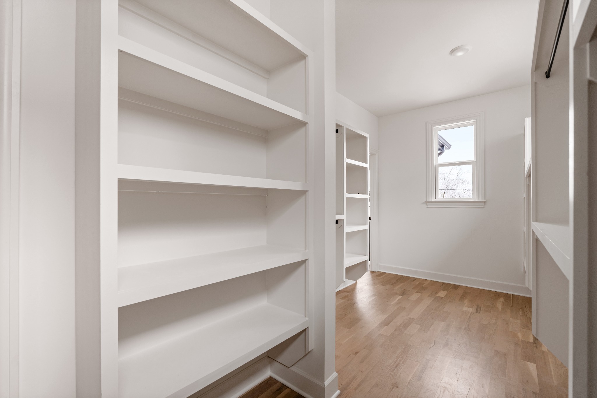 1037 Mitchell Road, Unit B Nashville, TN 37206 - Photo 44 of 50 a view of an empty room with wooden floor and a window