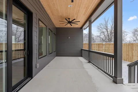a aerial view of a house with a yard and large trees