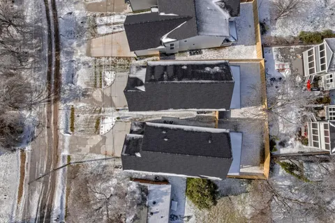 an aerial view of a house with a yard