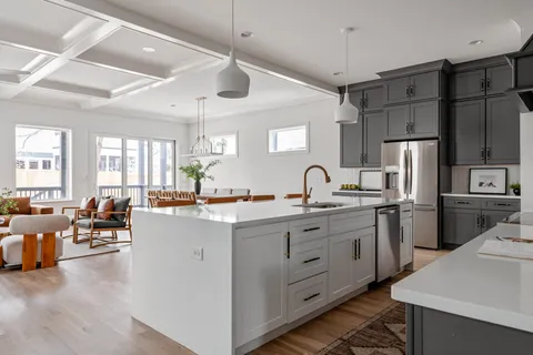 a kitchen with sink a refrigerator and furniture