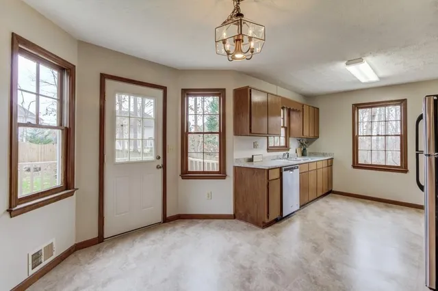 a view of kitchen with windows and chandelier