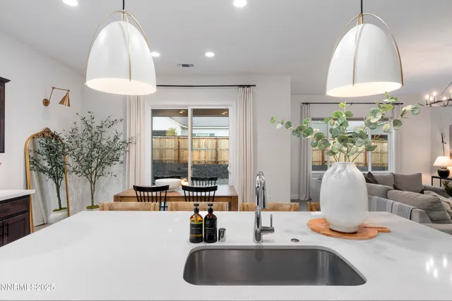 a kitchen with a chandelier a sink and a stove