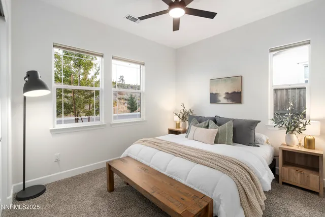 a bedroom with a large bed and a window