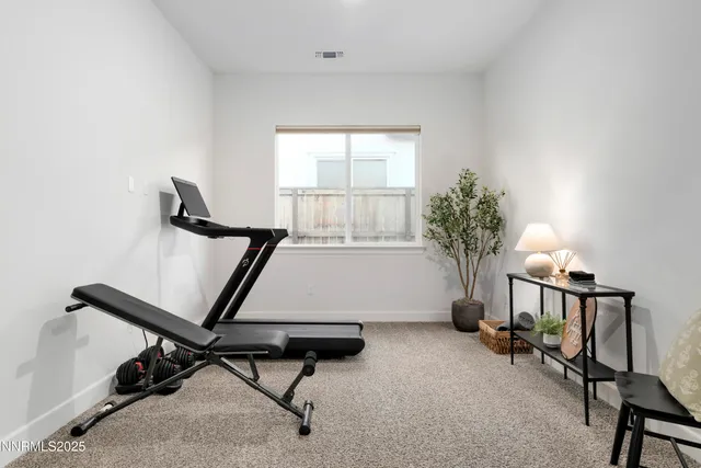 a room with gym equipment and a window
