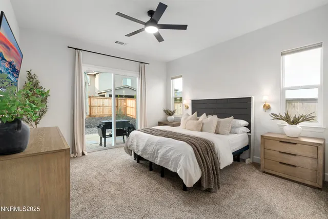 a spacious bedroom with a bed and a potted plant