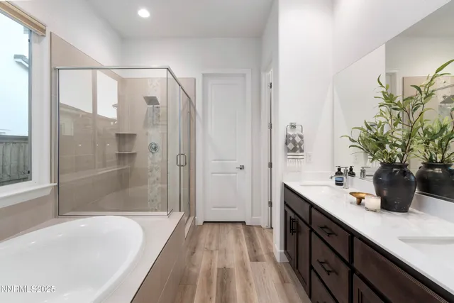 a bathroom with a tub sink and mirror