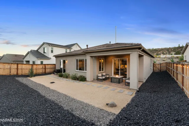 a view of a house with wooden fence