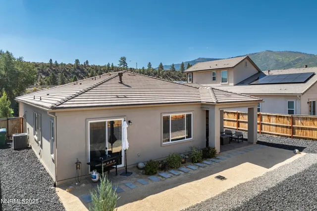 a view of a house with backyard porch and sitting area