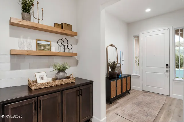 a view of a hallway to a livingroom with furniture