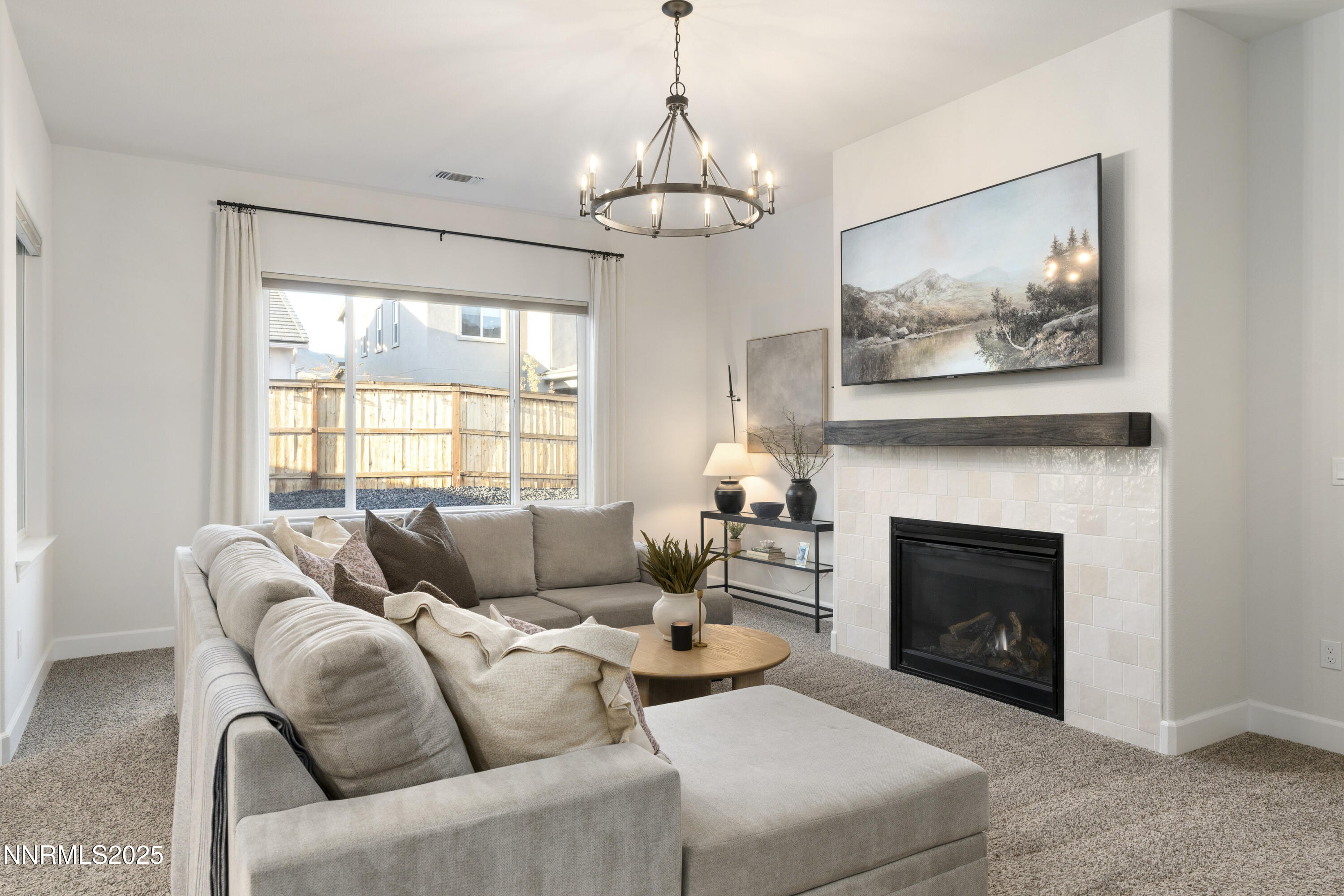 247 Starboard Drive Verdi, NV 89439 - Photo 5 of 41 a living room with furniture a fireplace and a chandelier
