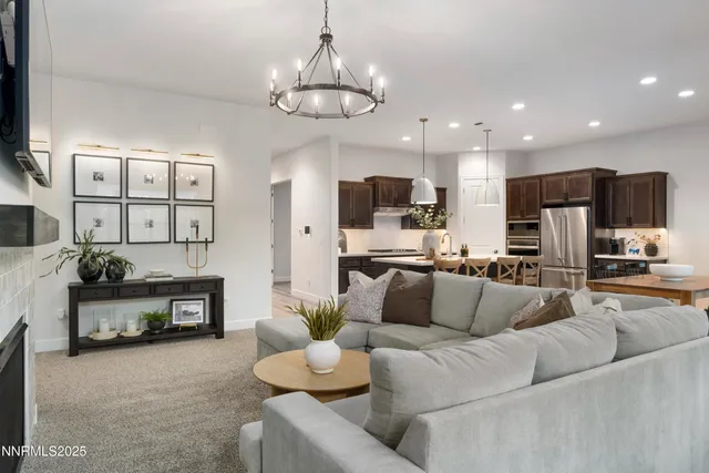 a living room with furniture kitchen view and a flat screen tv