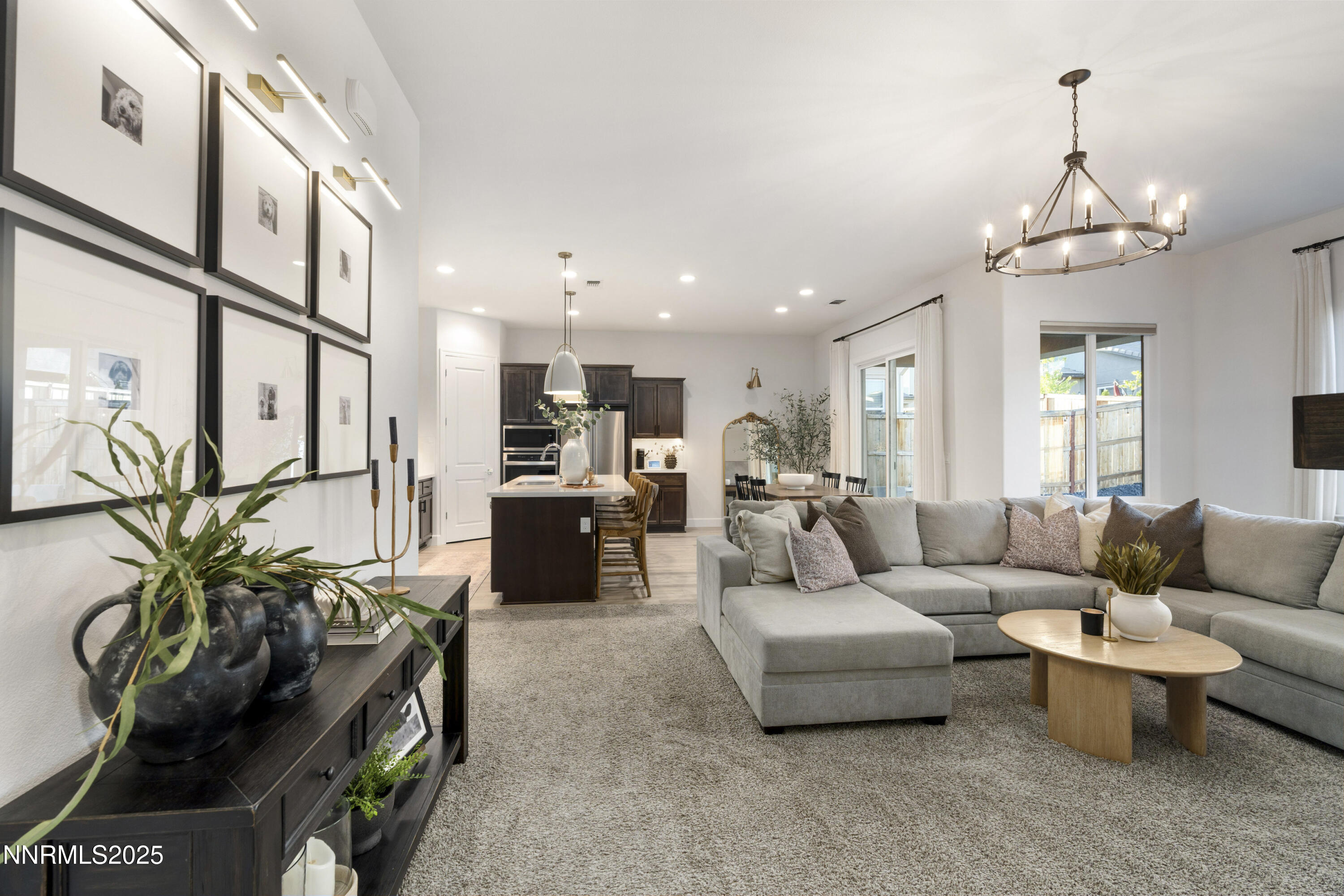 247 Starboard Drive Verdi, NV 89439 - Photo 8 of 41 a living room with furniture a chandelier and a view of kitchen