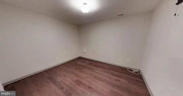 a bedroom with a bed and a lamp next to a window