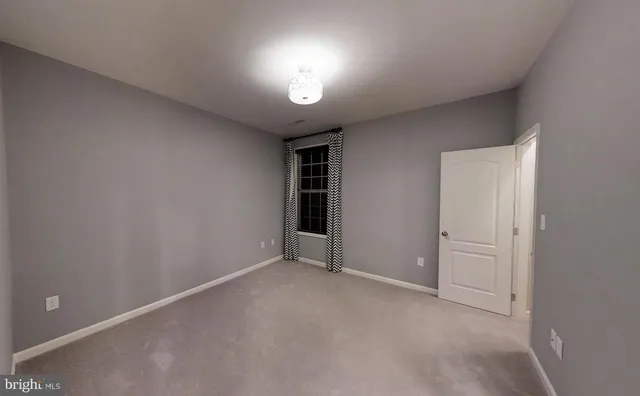 a kitchen with stainless steel appliances granite countertop a stove a dining table and chairs with the wooden floor