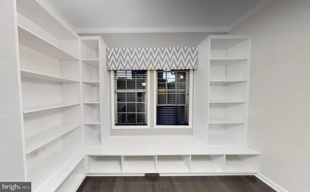 a view of a room with windows and stairs