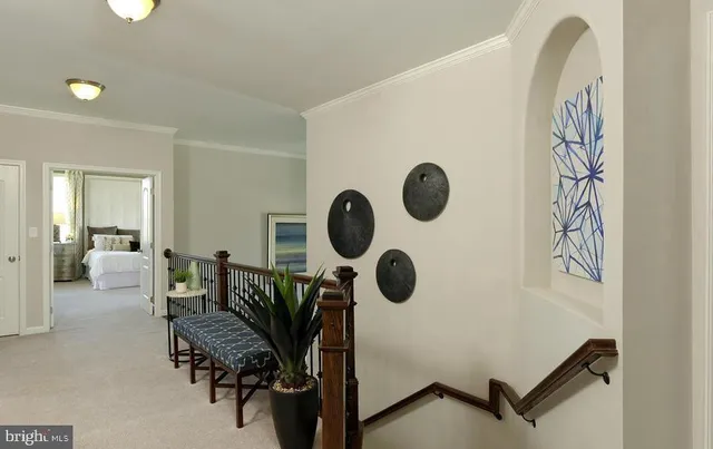 an empty room with wooden floor a ceiling fan a fireplace and windows