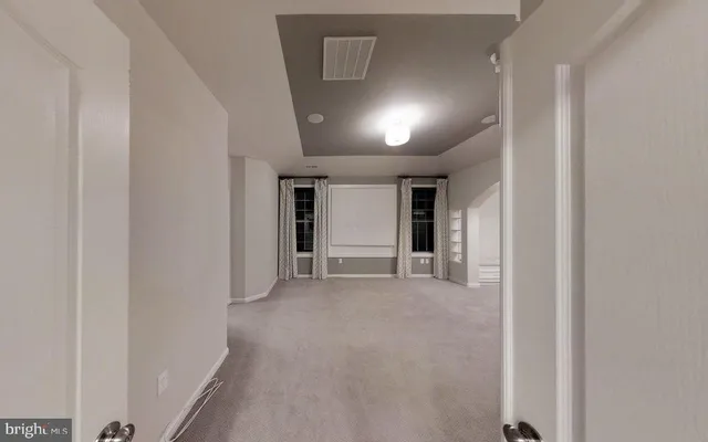 a view of a room with wooden floor